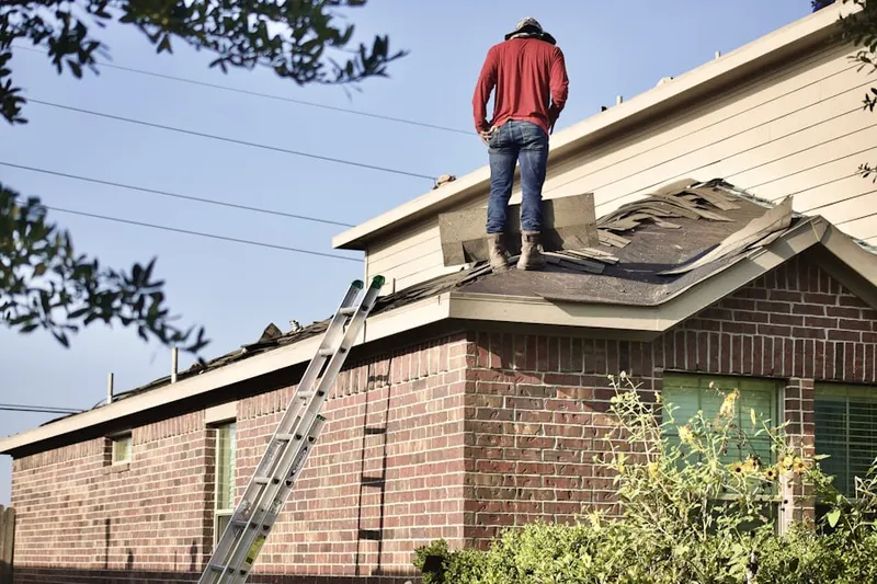Professional roofer working on a residential roof in Baxter
